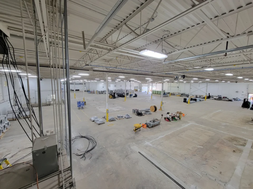 InterBuild industrial production floor in Bolton showing high-bay lighting, conduit and electrical distribution work by CBK Electric.